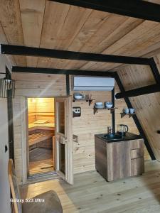 a wooden cabin with a sink in a room at Panorama Sormoni in Dzhimastaro