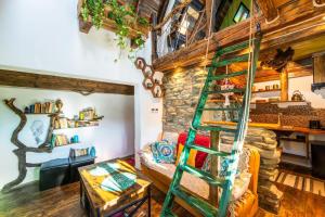 a spiral staircase in a room with a couch at Cucu's Nest in Sighişoara