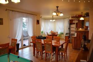 a dining room with a table and a pool table at Gospodarstwo Agroturystyczne Stajnia Grudki Energylandia Zator in Zator