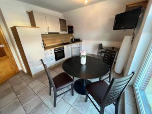 a kitchen with a table and chairs in a kitchen at Doris in Norddeich
