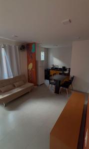 a living room with a couch and a table at Triplex Flecheiras in Flecheiras