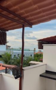 a balcony with a view of the ocean at Triplex Flecheiras in Flecheiras