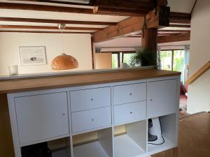 a kitchen with white cabinets and a counter at Ferienhaus Lisa am Silbersee in Frielendorf