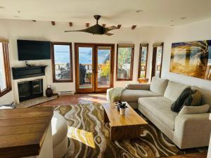 a living room with a couch and a table at Cliffside Villa W Ocean Views & Balcony in Avalon