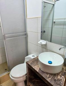 a bathroom with a sink and a toilet and a mirror at Hospedaje Wendy in Puerto Chicama