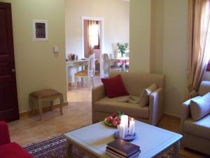 a living room with a couch and a table with candles at Zaggou Apartments in Amfikleia