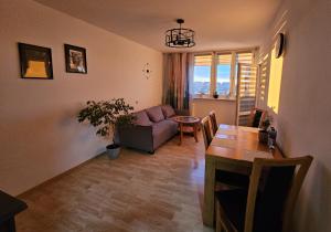 a living room with a couch and a table at Apartament WELES in Bolesławiec