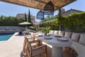 a patio with a table and chairs and a pool at OD Luxury Villa in Pylos
