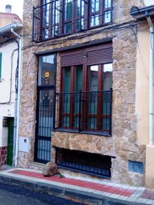 a building with a door and a balcony at Lujo en la Sierra in Becerril de la Sierra