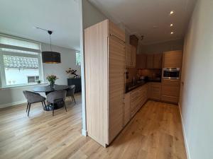 a kitchen with a table and a dining room at Prachtig en ruim appartement in centrum Lochem in Lochem