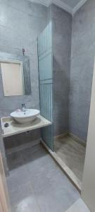 a bathroom with a sink and a mirror at شقة فندقية على البحر 3 in Hurghada