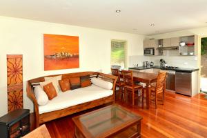 a living room with a couch and a table at Avalon Resort in Kerikeri