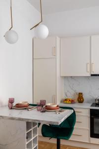 a kitchen with a table with plates on it at GOLDENGREEn in Sibiu +10 photos