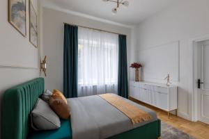 a bedroom with a green bed and a window at GOLDENGREEn in Sibiu