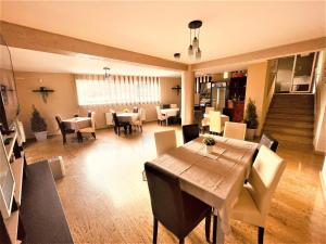 a dining room with a table and chairs at Vila Liliana in Predeal