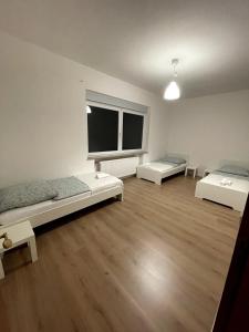 a large room with two beds and a large window at Apartment Roselin in Gschwend