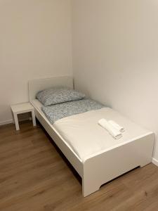 a white bed in a corner of a room at Apartment Roselin in Gschwend +3 photos