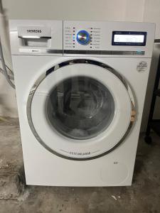 a white washing machine sitting in a room at Apartment Roselin in Gschwend