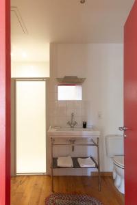 a bathroom with a sink and a toilet at Le charme au centre du village in Ménerbes +13 photos