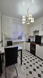 a kitchen with a table and a ceiling fan at Квартира in Bender