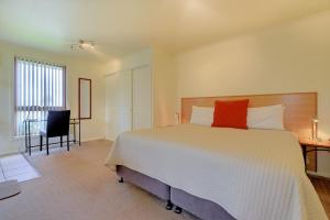a hotel room with a large bed and a large window at Aloft Boutique Accommodation in Strahan