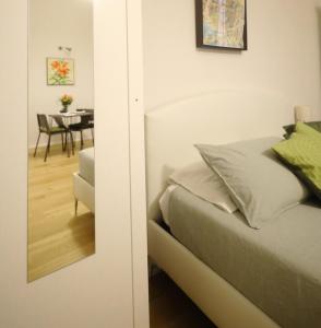 a bedroom with a bed and a dining room at Rolli House in Genova +4 photos