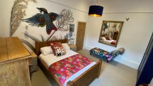 a bedroom with a bed with a bird on the wall at Church Retreat - A Magnificent Seaside Apartment-Award Winning in Hastings
