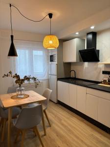 a kitchen with a wooden table and a dining room at VictrixHomes in León