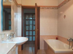 a bathroom with a tub and a sink at La casa di Cleo in Castiglione del Lago +34 photos