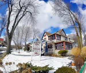 a house with a no parking sign in the snow at Blue Gables Bed and Breakfast in Niagara Falls