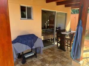 a room with a bed and a dining room with a table at Alma y Paz Beach House in Bejuco
