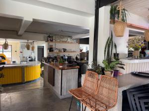 a kitchen with a counter and chairs in a room at The Cool Hostel in Coquimbo
