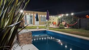 a swimming pool in a backyard at night at Quinta la hermosa in Villa María