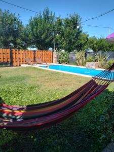 a hammock in a yard next to a pool at Quinta la hermosa in Villa María +7 photos