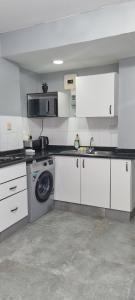 a kitchen with a sink and a washing machine at Oceanic Unit 67 - North Beach in Durban