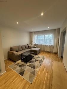 a living room with a couch and a table at Koreli apartment in Võru