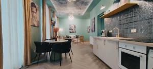a kitchen with a table and chairs in a room at Appartements design - Uniques - Centre in Bagnères-de-Bigorre
