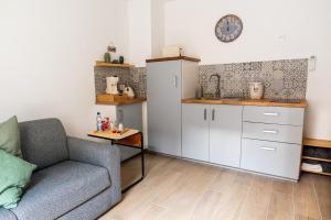 a living room with a couch and a table at Au Cocon de J in Obernai