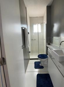 a bathroom with a toilet and a sink and a shower at Apartamento Cop 30 in Ananindeua