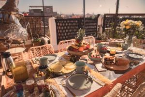 une table avec des assiettes de nourriture sur un balcon dans l'établissement Riad Näjma privatisation, 2 Bassins, à Marrakech