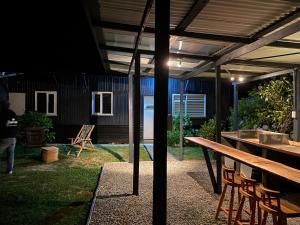 a patio with a wooden table and a wooden bench at Hostel Cala 816 in Frutillar