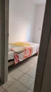 a bed in a white room with a bed frame at Casa vicino al mare in Montesilvano