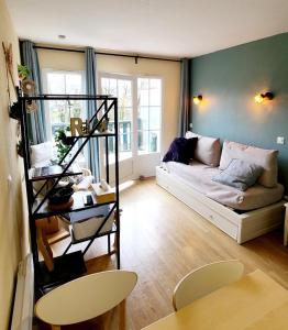 un salon avec un canapé et une table dans l'établissement Charmant Duplex en bord de Dordogne - Argentat- Corrèze, à Argentat