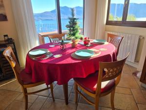 a dining room table with a christmas tree on it at Lago Maggiore - Traumbalkon mit Seeblick & Pool und 2 SZ in Oggebbio