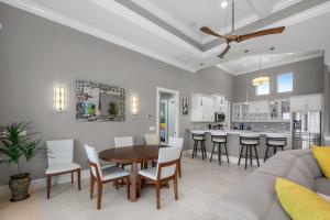 a living room with a table and chairs and a kitchen at Memories on Madison by Sun Palace Vacations in Fort Myers Beach +36 photos