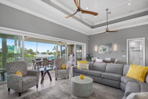 a living room with a couch and chairs and a table at Memories on Madison by Sun Palace Vacations in Fort Myers Beach