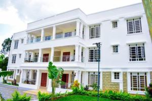 a large white building with a lot of windows at The Jades At Riat in Kisumu