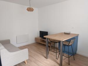 a dining room with a table and two chairs at Appartement moderne et bohème in Vittel