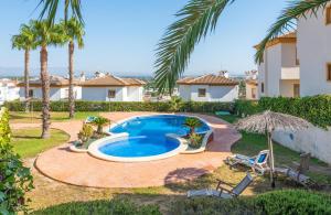 a backyard with a swimming pool and palm trees at Casa Serena 2 in Rojales