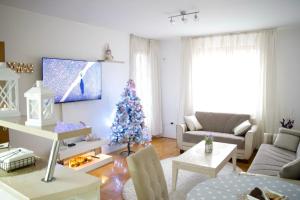 a living room with a christmas tree in it at My Place in Lukavica